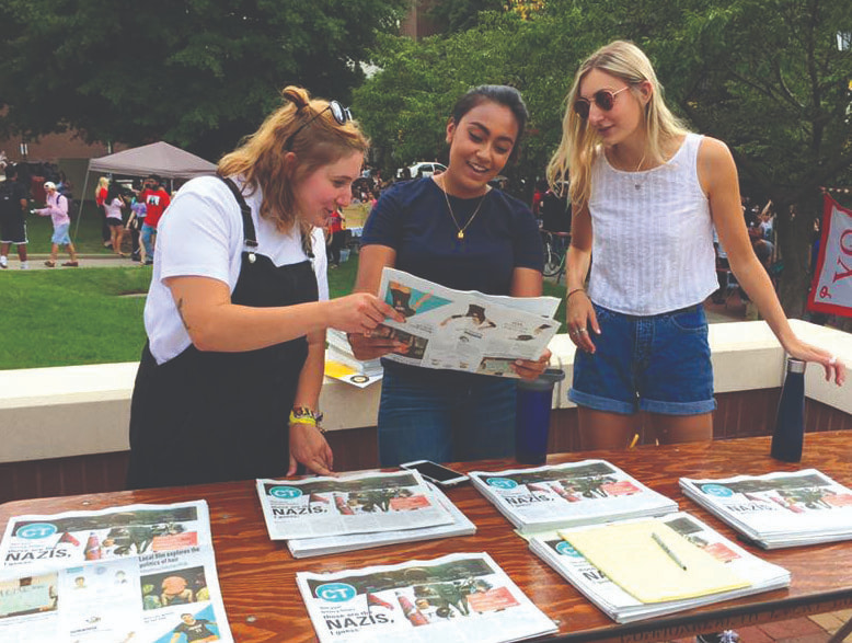 Commonwealth Times staff members review their latest issues during a VCU Student recruitment fair.